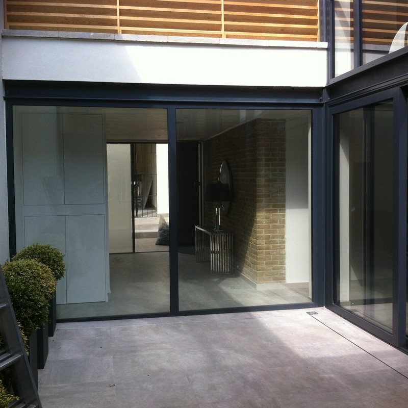 Floor-to-ceiling sliding doors opening to courtyard in Charlton