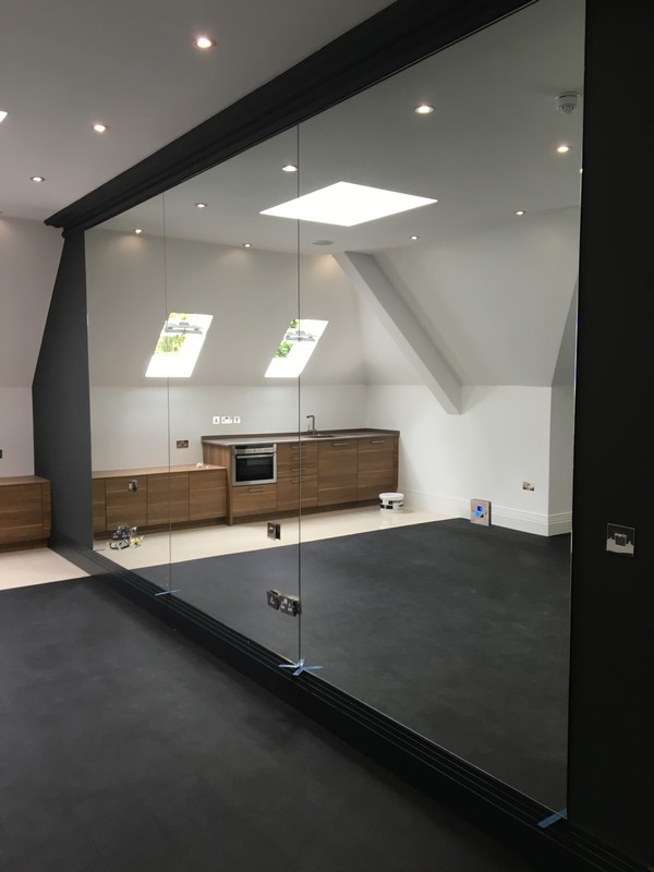 Frameless glass partition in loft conversion by Charlton glaziers