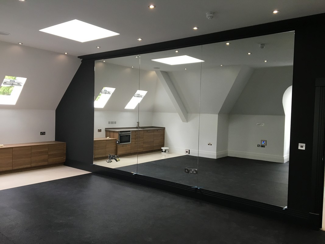 Frameless glass wall dividing loft conversion in Charlton