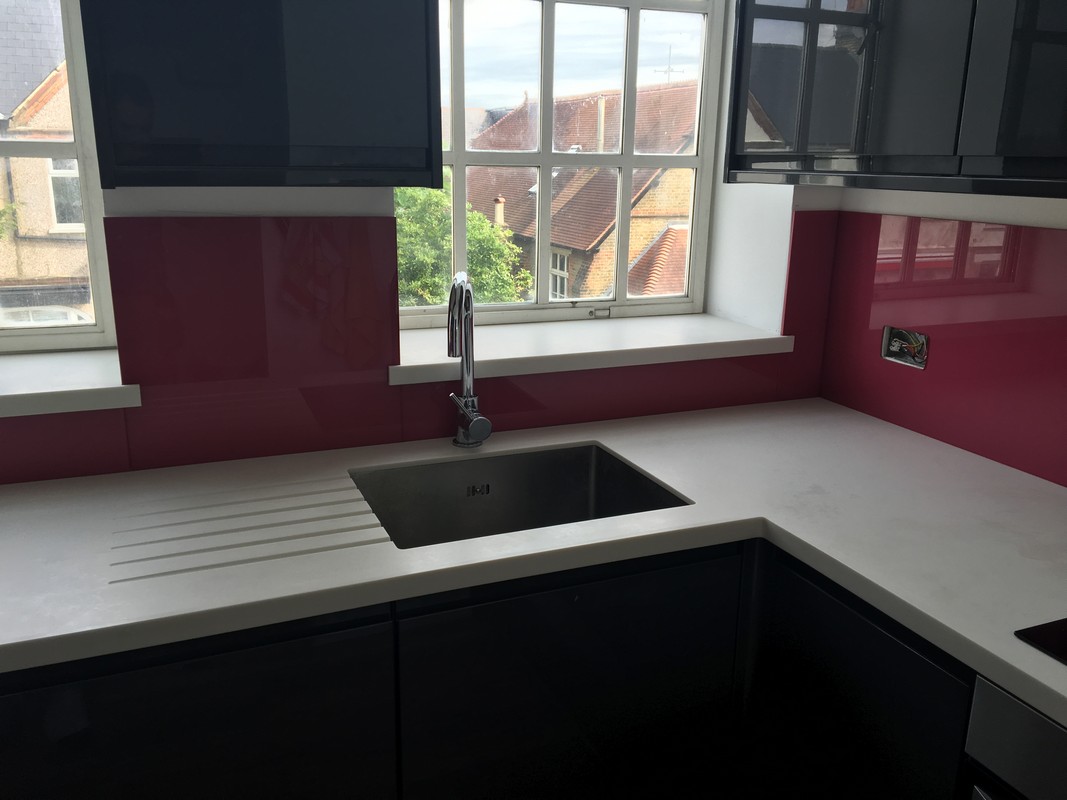 Deep plum coloured glass splashback in modern Charlton kitchen